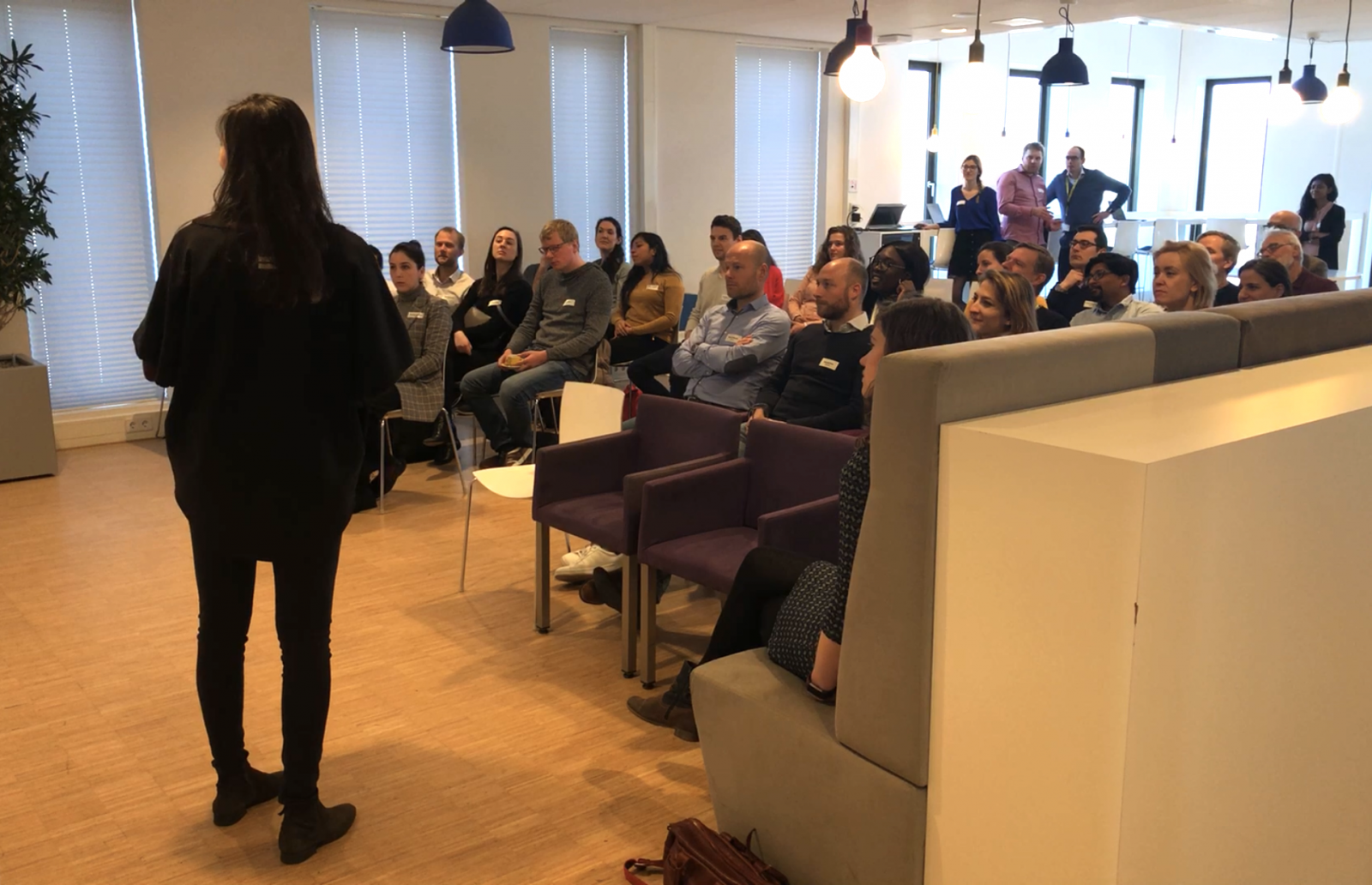 Woman talking to a group of people in a room